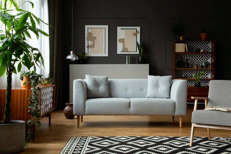 real-photo-of-dark-grey-living-room-interior-with-posters-and-mo.jpg